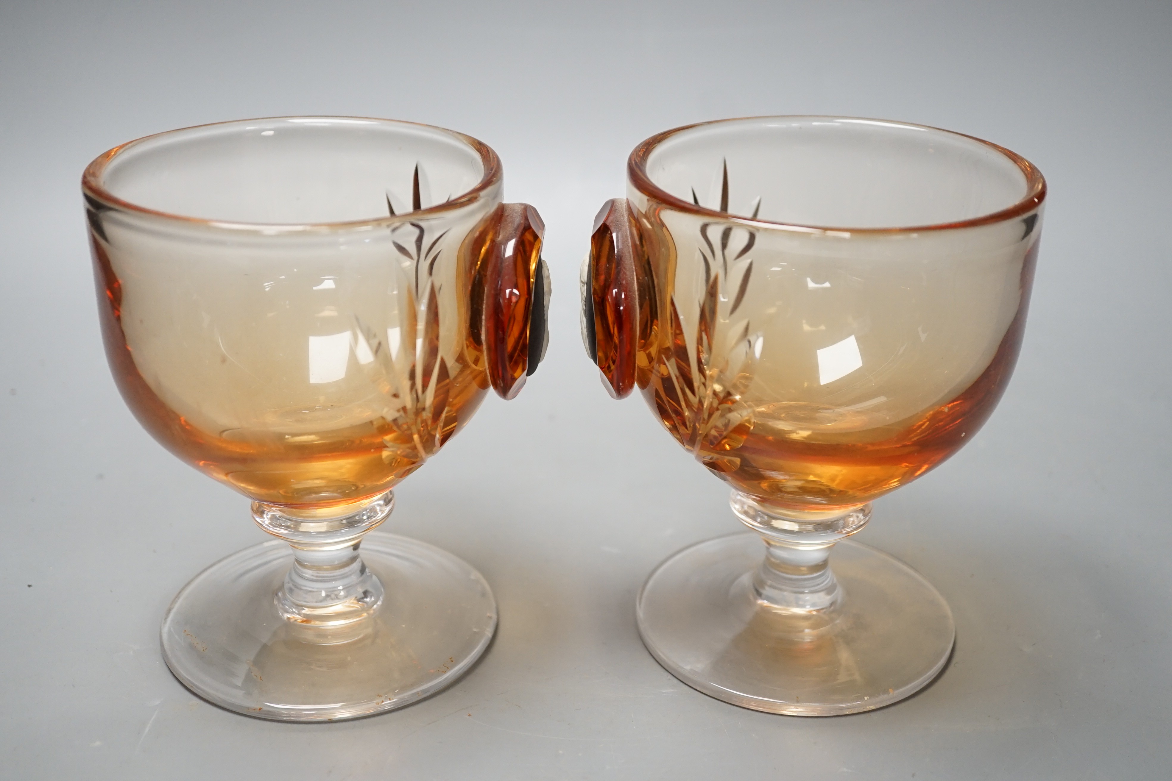 A pair of Wedgwood glass goblets with inset jasper commemorative plaques depicting QEII and Duke of Edinburgh, 13cms high